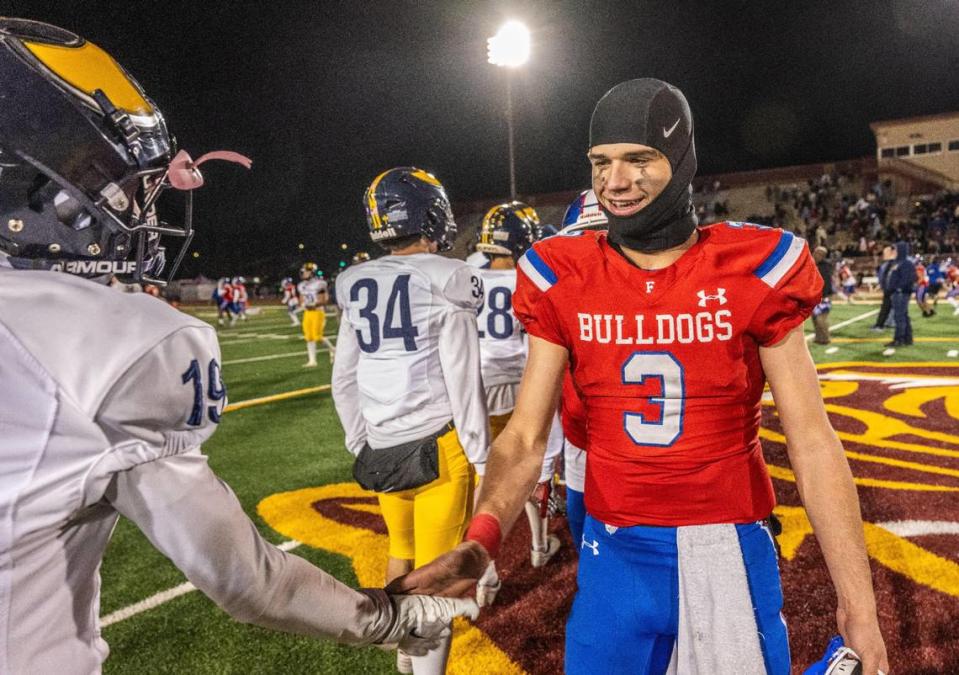 Folsom Bulldogs quarterback Ryder Lyons (3) shakes hands with the Oak Ridge Trojans’ Jacob Potter (19) after the Bulldogs’ victory in the CIF Sac-Joaquin Section Division I football championship game on Friday, Nov. 24, 2023, at Hughes Stadium.