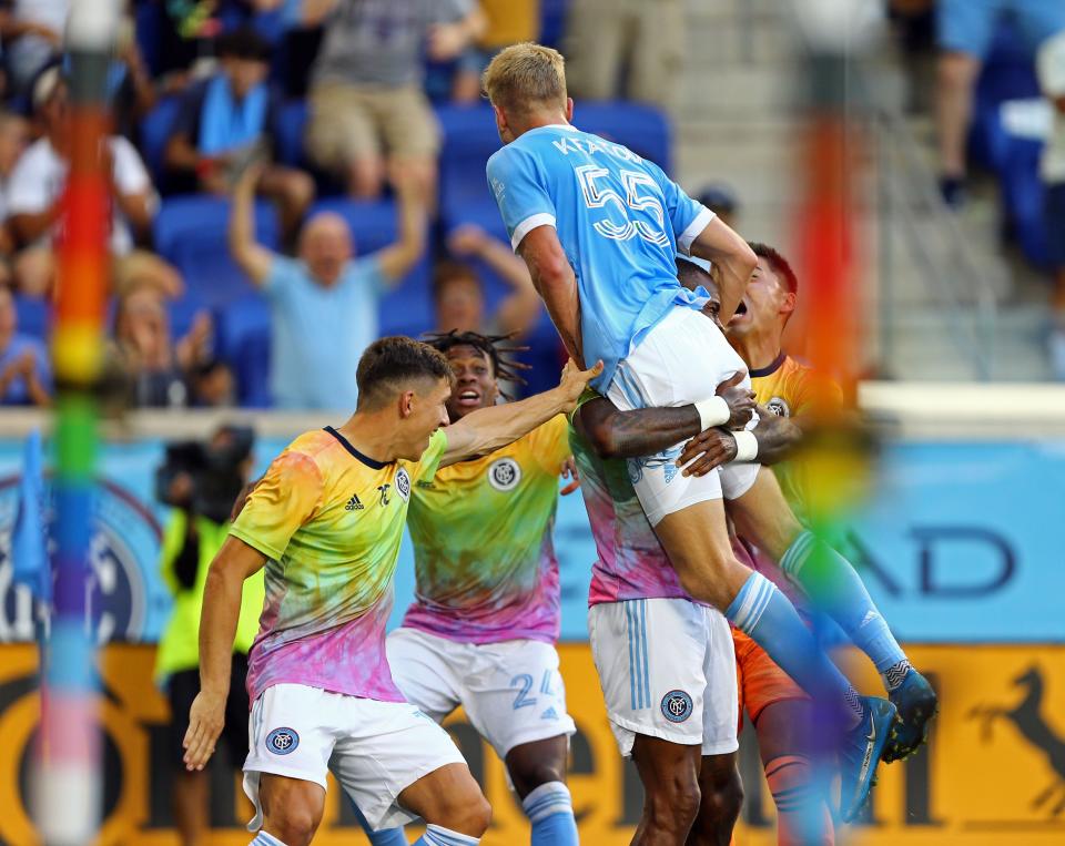 New York City FC midfielder Keaton Parks (55) leaps into the arms of teammates while celebrating his goal against D.C. United at Red Bull Arena.