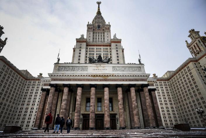 <span class="caption">U.S. universities are cutting ties with their Russian counterparts, such as Moscow State University, shown here. </span> <span class="attribution"><a class="link " href="https://www.gettyimages.com/detail/news-photo/students-walk-towards-the-main-building-of-the-moscow-state-news-photo/1231041466?adppopup=true" rel="nofollow noopener" target="_blank" data-ylk="slk:Alexander Nemenov/AFP via Getty Images">Alexander Nemenov/AFP via Getty Images</a></span>