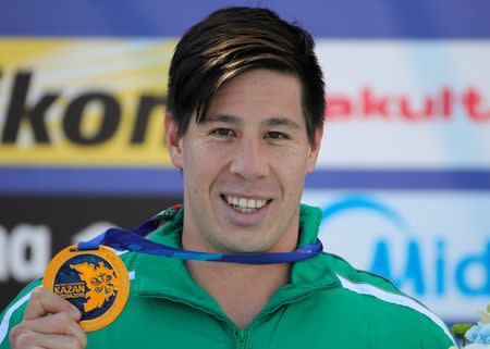 Chad Ho of South Africa poses with his gold medal after competing in the men's 5km open water race at the Aquatics World Championships in Kazan, Russia, July 25, 2015. REUTERS/Hannibal Hanschke