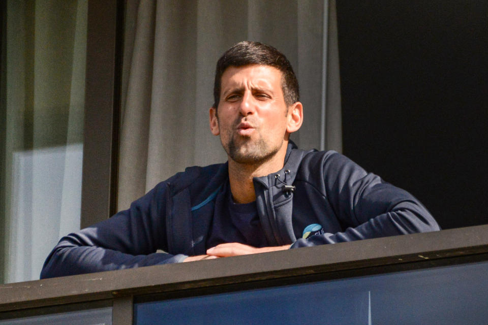 Men's world number one tennis player Novak Djokovic of Serbia gestures from his hotel balcony on the last day of his two-week quarantine in Adelaide on January 28, 2021, one of the locations where players have quarantined upon their arrival ahead of the Australian Open tennis tournament in Melbourne. (Photo by Brenton EDWARDS / AFP) / -- IMAGE RESTRICTED TO EDITORIAL USE - STRICTLY NO COMMERCIAL USE -- (Photo by BRENTON EDWARDS/AFP via Getty Images)