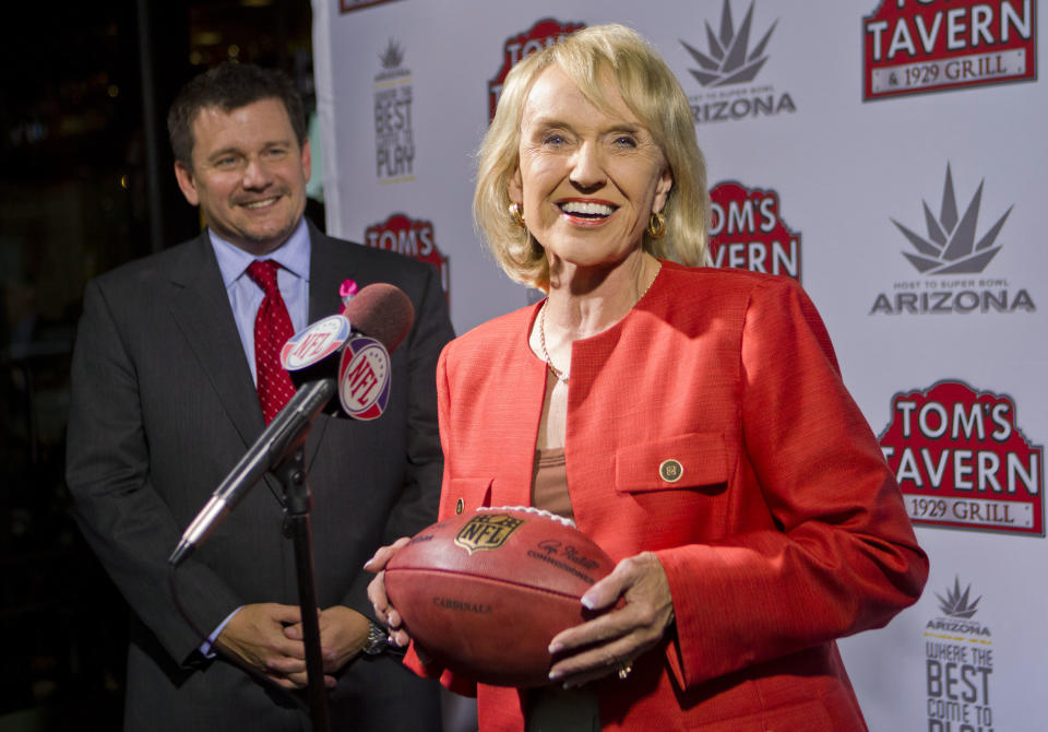 Arizona Cardinals president Michael Bidwill, left, and Arizona Gov. Jan Brewer smile Tuesday, Oct. 11, 2011, in Phoenix, after NFL owners awarded the 2015 Super Bowl football game to the Phoenix area. (AP Photo/The Arizona Republic, Michael Chow) MARICOPA COUNTY OUT NO SALES