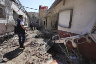 A man walks through a heavily damaged hospital in the city of Afrin, Syria, Sunday, June 13, 2021. Shells have hit the hosptal Saturday, killing at least 13 people, including two medical staff and two ambulance drivers. It was not immediately clear who was behind the shelling, which came from areas where government troops and Kurdish-led fighters are deployed. (AP Photo/Ghaith Alsayed)