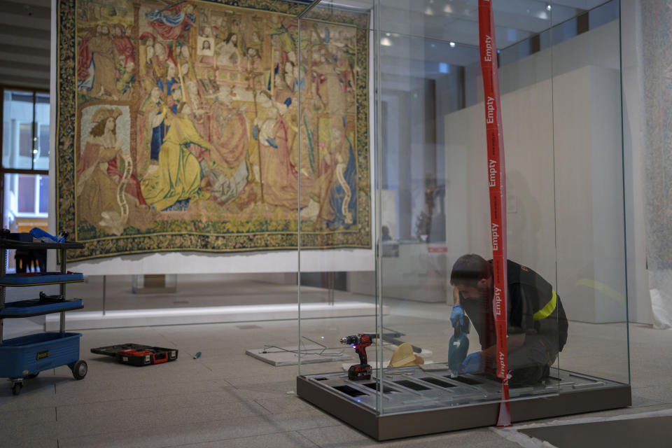 A staff member of the museum sets up an installation at the Royal Collections Gallery in Madrid, Spain, Friday, May. 19, 2023. Spain is set to unveil what is certain be one of Europe's cultural highlights this year with the opening in Madrid of The Royal Collections Gallery next month. (AP Photo/Manu Fernandez)