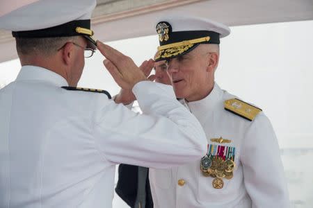 FILE PHOTO: U.S. Navy Rear Admiral Jim Malloy (R), commander of Carrier Strike Group 10, is saluted during a change of command ceremony onboard the USS Dwight D. Eisenhower during deployment in Norfolk, Viginia, U.S., in this undated photo. U.S. Navy/Handout via REUTERS