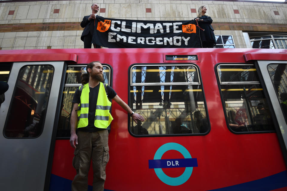 File photo dated 17/04/19 of climate activists Cathy Eastburn, 51 from Lambeth, south London and Luke Watson, 29, of Manuden, Essex,(both top) and Mark Ovland, 35 of Somerton, Somerset, glued to a Docklands Light Railway train at Canary Wharf station.