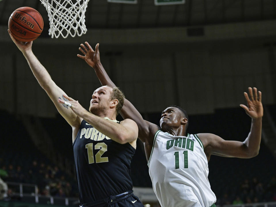 Purdue forward Evan Boudreaux goes to the basket against Ohio forward Slyvester Ogbonda during the first half of an NCAA college basketball game, Tuesday, Dec. 17, 2019, in Athens, Ohio. (AP Photo/David Dermer)