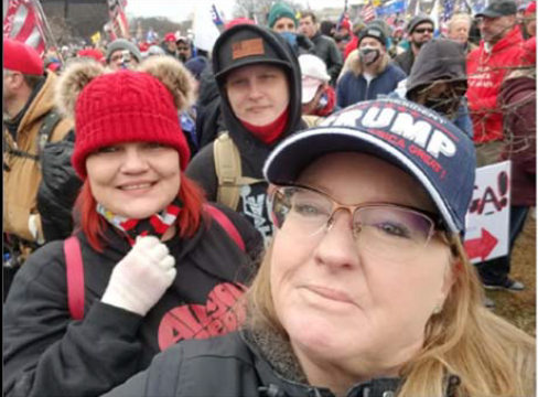 The FBI has identified the Petersons as being in Washington, D.C., on Jan. 6, the day of the Capitol insurrection. Shelly Peterson (in the Trump hat) shared on Facebook that her son, Russell Peterson (in the flag hat and hoodie), stormed the Capitol and sat in Nancy Pelosi's chair. Also in the photo is Russell Peterson's wife, Elizabeth (in the red cap). Russell and Elizabeth Peterson are from Rochester in Beaver County, Pennsylvania.