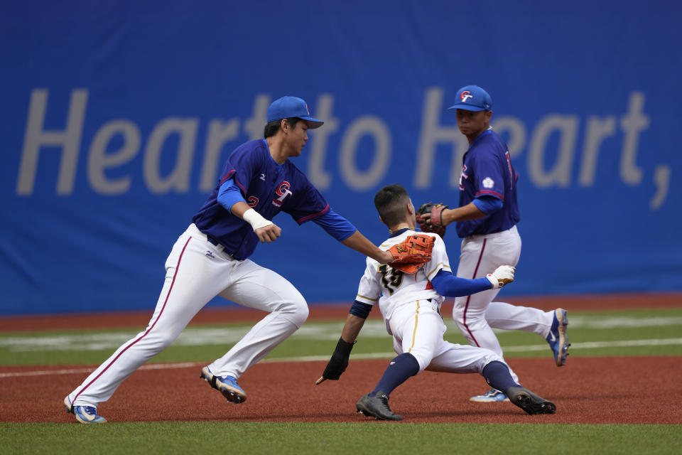 Taiwan's Lin Tzu-Hao tags out Hong Kong's Cheng Hoi Ting during a stage group round B Baseball Men game for the 19th Asian Games in Hangzhou, China on Tuesday, Oct. 3, 2023. At the Asian Games China has been going out of its way to be welcoming to the Taiwanese athletes, as it pursues a two-pronged strategy with the goal of taking over the island, which involves both wooing its people while threatening it militarily. (AP Photo/Ng Han Guan)