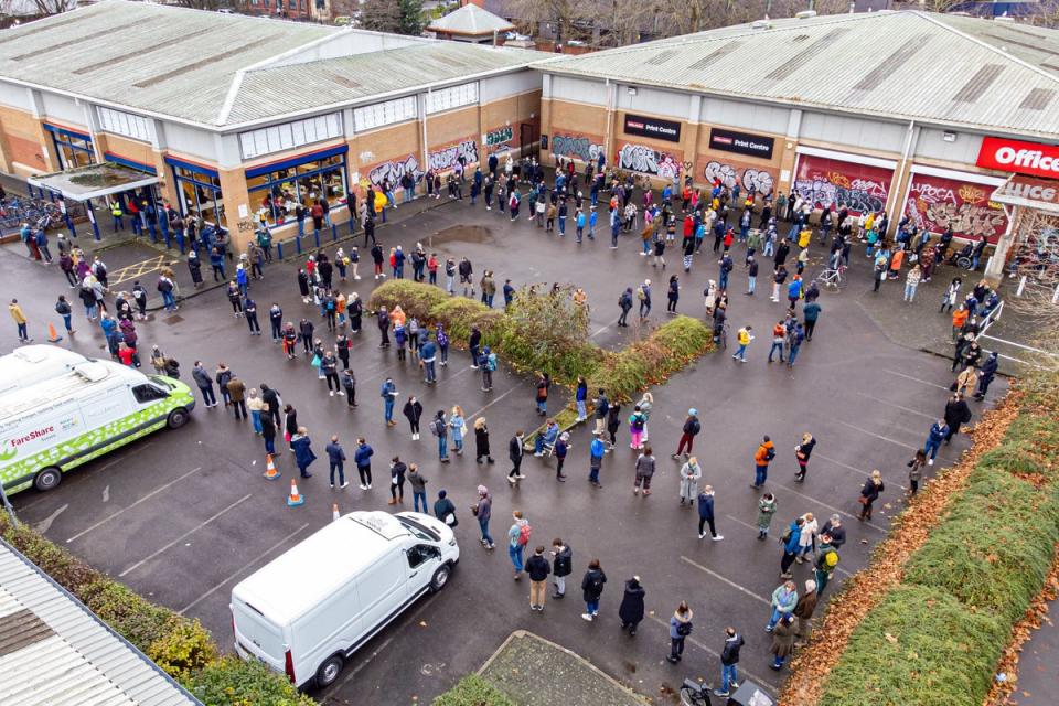 Hundreds of people queue at a vaccination centre in Bristol, as the coronavirus booster vaccination programme is ramped up to an unprecedented pace of delivery, with every eligible adult in England being offered a top-up injection by the end of December (PA)