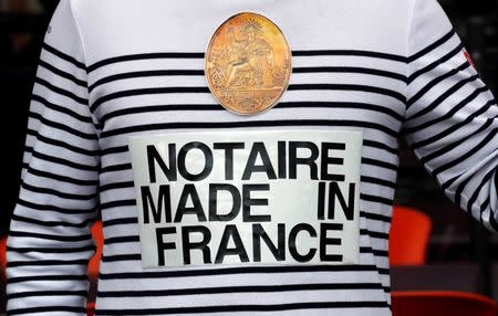A notary wearing a sweatshirt reading "Notary made in France" demonstrates during their first-ever public protest against a plan to chip away at rules shielding them from competition in Marseille September 17, 2014. REUTERS/Jean-Paul Pelissier