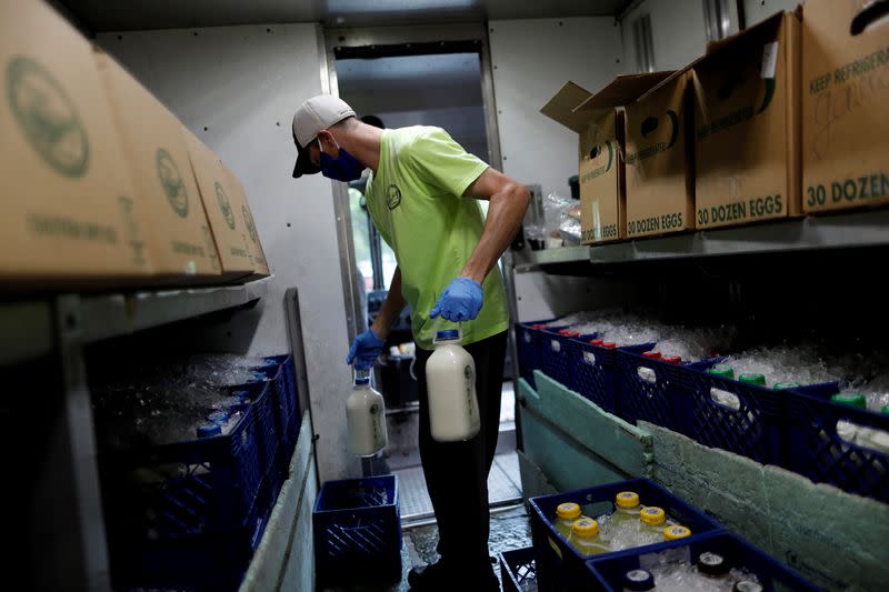 A man delivers milk at Capitol Hill as coronavirus disease (COVID-19) continues to spread in Washington
