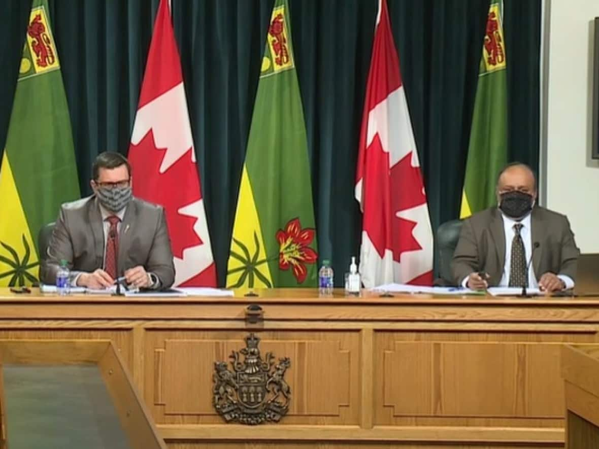 Dr. Saqib Shahab, Saskatchewan's chief medical health officer, right, and Health Minister Paul Merriman, left, are shown at a previous news conference. On Thursday, they updated pandemic protocols in Saskatchewan. (CBC - image credit)