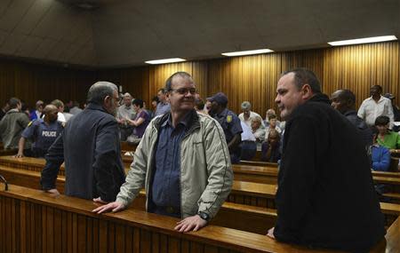 Members of the right-wing "Boeremag" Tom Voster (L), brothers Mike and Andre du Toit stand in the dock ahead of their sentencing at Pretoria High Court October 29, 2013. REUTERS/Stringer