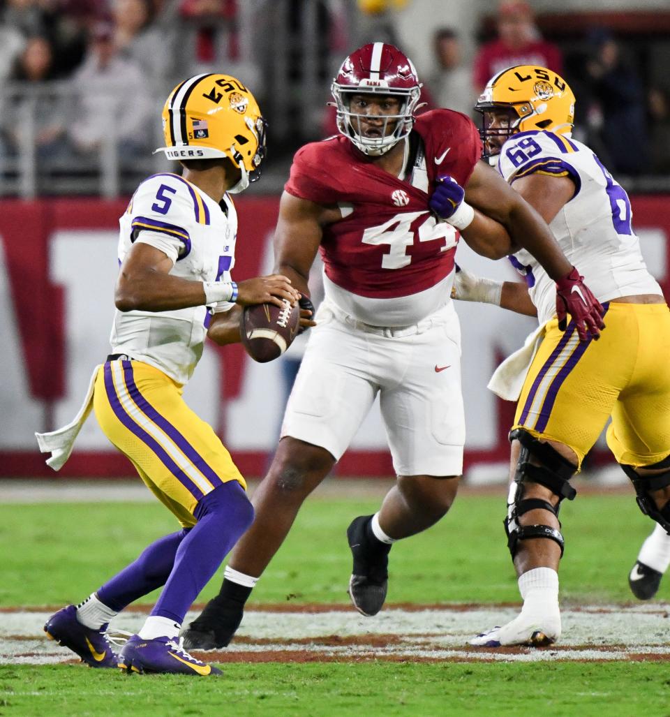 Nov 4, 2023; Tuscaloosa, Alabama, USA; LSU Tigers offensive lineman Charles Turner III (69) grabs Alabama Crimson Tide defensive lineman Damon Payne Jr. (44) by the jersey as he rushes LSU Tigers quarterback Jayden Daniels (5) at Bryant-Denny Stadium. Mandatory Credit: Gary Cosby Jr.-USA TODAY Sports