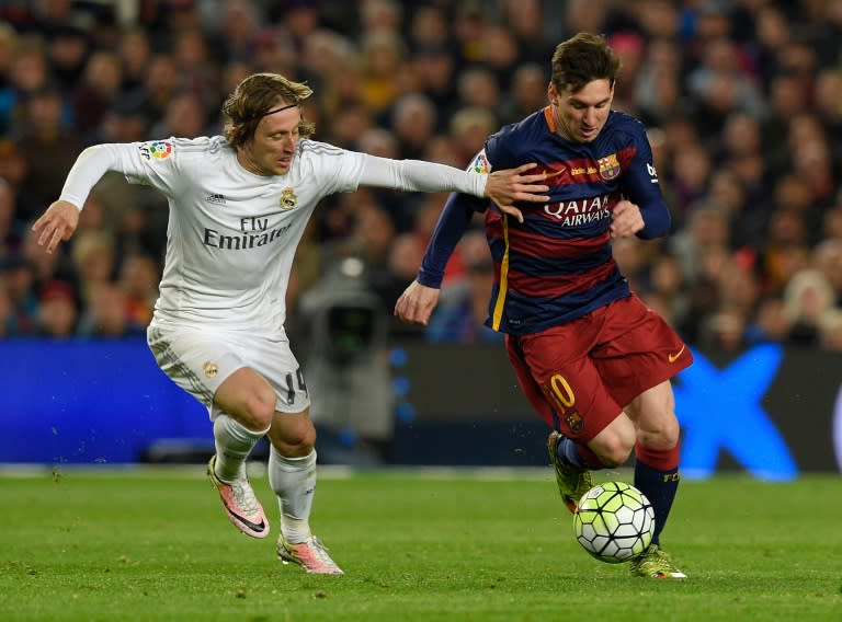 Barcelona's Argentinian forward Lionel Messi vies with Real Madrid's Croatian midfielder Luka Modric during the Spanish league "Clasico" football match in Barcelona on April 2, 2016