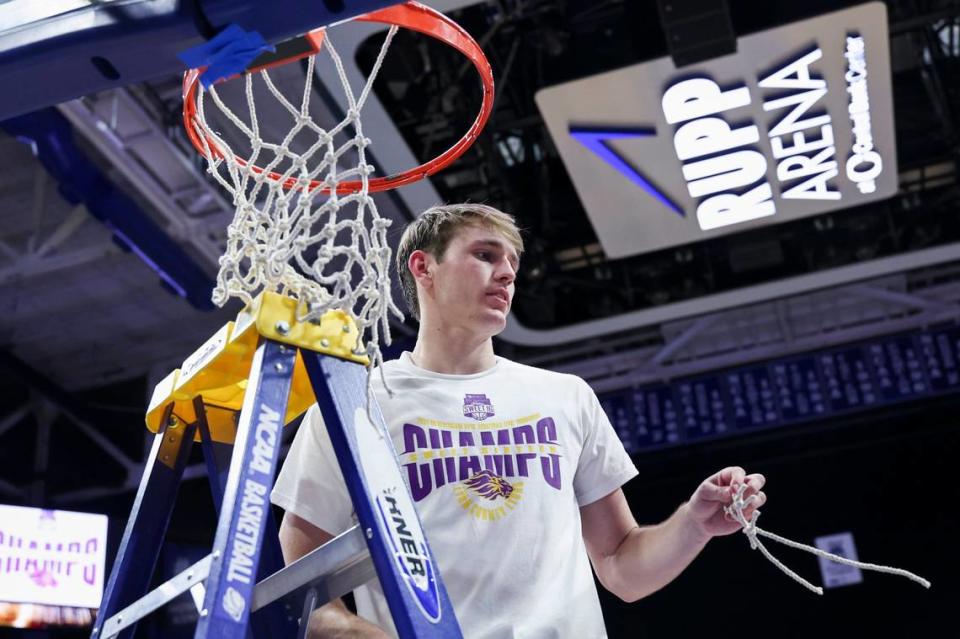Lyon County’s Travis Perry cuts a part of the net after the Lyons defeated Harlan County 67-58 in the Boy’ Sweet 16 finals at Rupp Arena on March 23.
