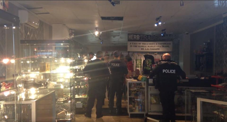 Halifax police officers questioned staff and customers at Farm Assists on Gottingen Street Friday.