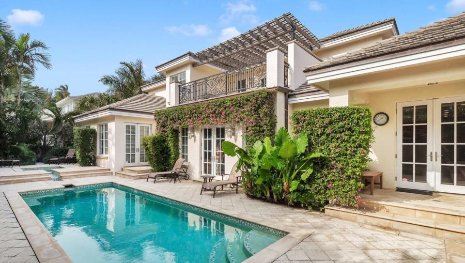 The rear of the house that just sold for a recorded $10.25 million at 220 Esplanade Way in Palm Beach has a pergola-topped terrace overlooking the pool.