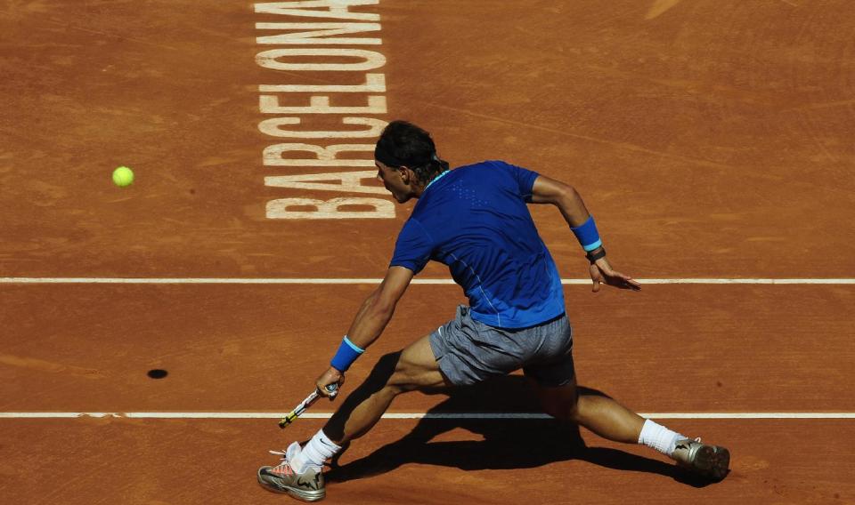 Rafael Nadal returns the ball to Albert Ramos during the Barcelona open tennis in Barcelona, Spain, Wednesday, April 23, 2014. (AP Photo/Manu Fernandez)