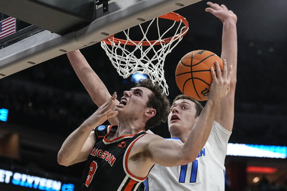 Princeton guard Ryan Langborg (3) heads to the basket against Creighton center Ryan Kalkbrenner (11) in the first half of a Sweet 16 round college basketball game in the South Regional of the NCAA Tournament, Friday, March 24, 2023, in Louisville, Ky. (AP Photo/John Bazemore)