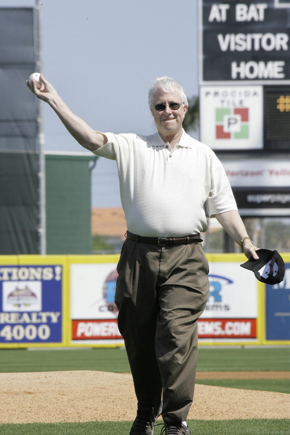 FILE - St. Louis Post Dispatch baseball columnist Rick Hummel throws the ceremonial first pitch before the start of the Florida Marlins and St. Louis Cardinals baseball spring training game Wednesday, Feb. 28, 2007, in Jupiter, Fla. Hummel, an esteemed writer who covered the St. Louis Cardinals and Major League Baseball for five decades for the Post-Dispatch until his retirement in 2022, died Saturday, May 20, 2023, after a short, unspecified illness the Post-Dispatch said Monday. He was 77. (AP Photo/Rick Bowmer, File)