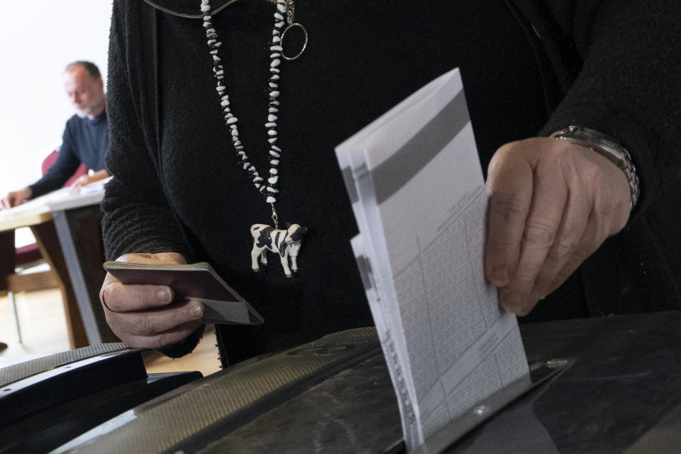 Lawmaker Caroline van der Plas, leader of the populist BBB Farmer Citizen Movement wears a little cow on her necklace when casting her vote for the provincial elections in Okkenbroek, eastern Netherlands, Wednesday, March 15, 2023. Local elections with national consequences opened Wednesday in the Netherlands as voters cast their ballots for the country's 12 provincial legislatures, which in turn elect the national parliament's upper house. (AP Photo/Peter Dejong)