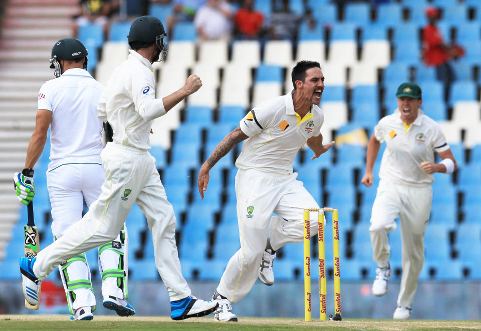 Australia's bowler Mitchell Johnson, second from right, with teammates reacts after dismissing South Africa's batsman Faf du Plessis, left, for 3 runs on the second day of their their cricket Test match at Centurion Park in Pretoria, South Africa, Thursday, Feb. 13, 2014. (AP Photo/ Themba Hadebe)