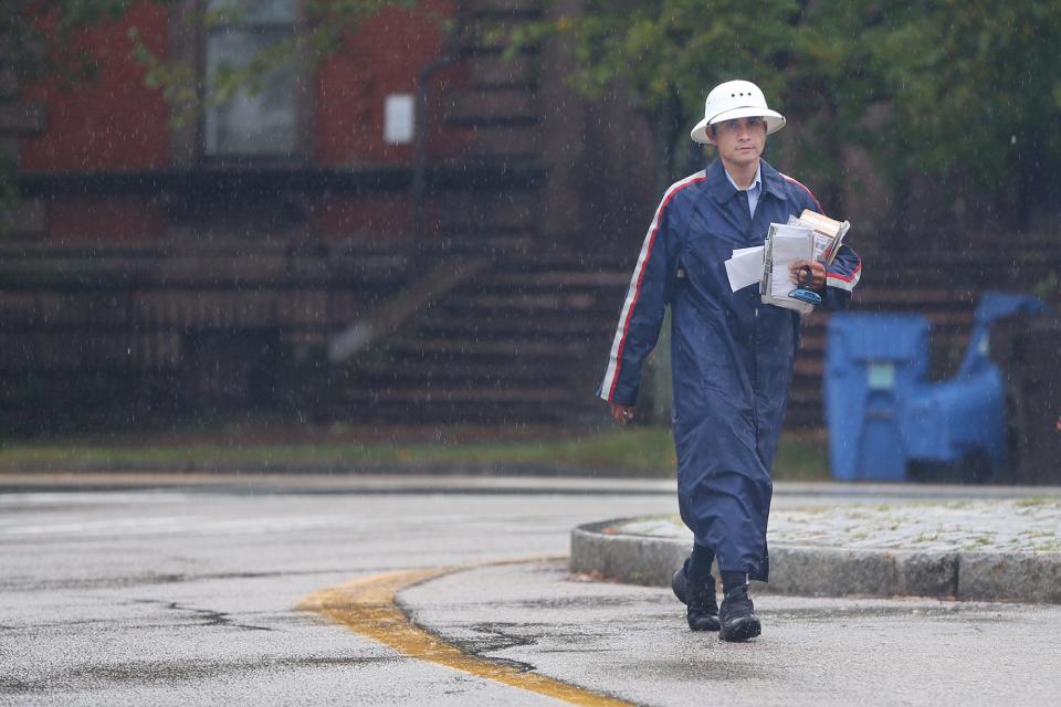 A mail carrier makes rounds in Portsmouth during the rain storm Thursday, Sept. 22, 2022.