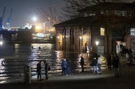 Water from the Elbe is pushed onto the fish market during a storm surge in Hamburg, Germany, Thursday, Dec. 21, 2023. The Federal Maritime and Hydrographic Agency predicted a severe storm surge in Hamburg overnight due to the storm depression "Zoltan." (Bodo Marks/dpa via AP)
