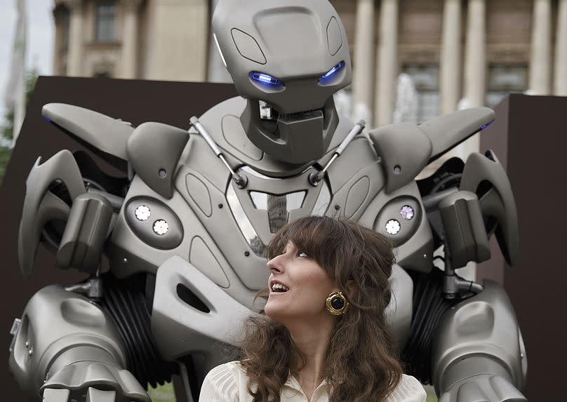 A woman takes her photo with Titan the Robot, in Bucharest, Romania, Monday, May 11, 2015