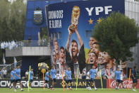 Argentina's Lionel Messsi, center, and Angel Di Maria, center left, attends a team training session at the Argentina Soccer Association in Buenos Aires, Argentina, Tuesday, March 21, 2023.(AP Photo/Gustavo Garello)