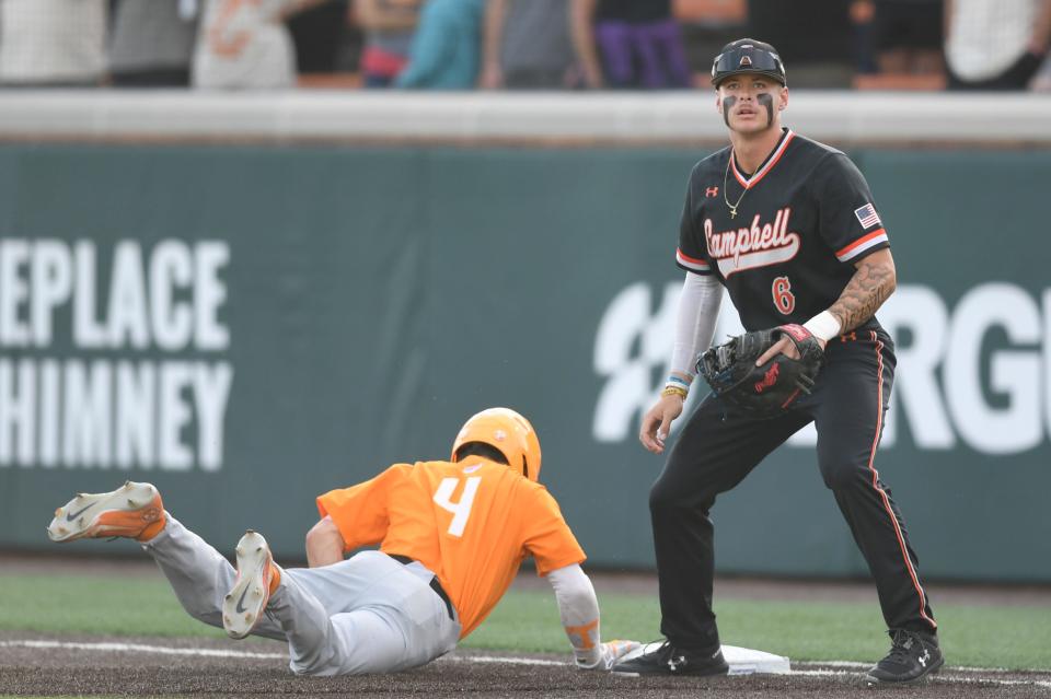 Tennessee’s Seth Stephenson (4) slides safely back to first base as Campbell's Drake Pierson (6) holds him on during the NCAA Baseball Tournament Knoxville Regional between the Tennessee Volunteers and Campbell Fighting Camels held at Lindsey Nelson Stadium on Saturday, June 4, 2022.