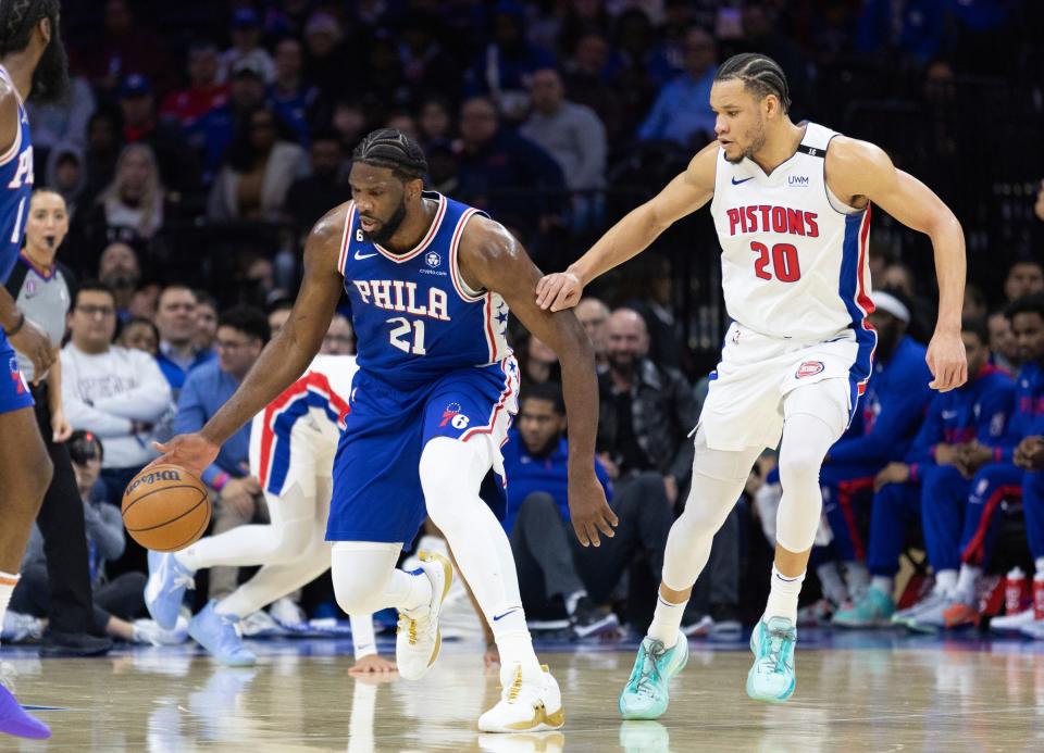 76ers center Joel Embiid dribbles up court in front of Pistons forward Kevin Knox II during the first quarter of the 147-116 loss to the 76ers on Tuesday, Jan. 10, 2023, in Philadelphia.