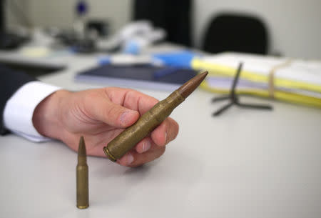 A police chief from the Bank Stealing Investigations Department holds the ammunition of a .50 machine gun, which is used by bank robbers, in Sao Paulo, Brazil February 8, 2019. REUTERS/Amanda Perobelli