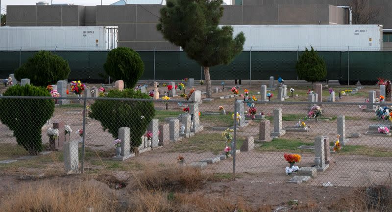 FILE PHOTO: Refrigerated trailers are seen parked at the rear of the El Paso County Office of the Medical Examiner in El Paso