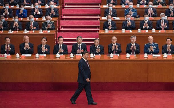 PHOTO: Chinese President Xi Jinping is applauded by senior members of the government and delegates as he walks to the podium before his speech at the 20th National Congress of the Communist Party of China, Oct. 16, 2022 in Beijing. (Kevin Frayer/Getty Images)