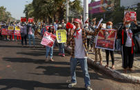 Demonstrators display placards with pictures of deposed Myanmar leader Aung San Suu Kyi to protest against the military coup in Yangon, Myanmar, Wednesday, Feb. 17, 2021. The U.N. expert on human rights in Myanmar warned of the prospect for major violence as demonstrators gather again Wednesday to protest the military's seizure of power. (AP Photo)