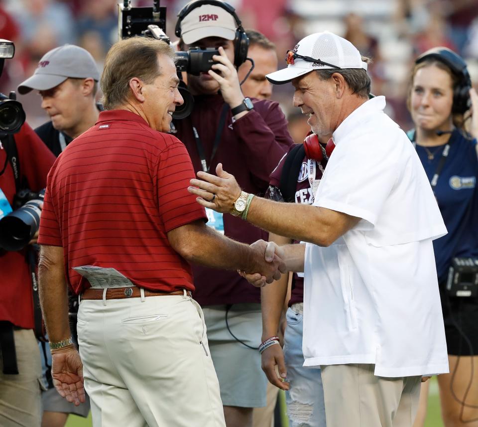 COLLEGE STATION, TEXAS - OCTOBER 09: Head coach Nick Saban of the Alabama Crimson Tide  and head coach Jimbo Fisher of the Texas A&M Aggies  meet before the game at Kyle Field on October 09, 2021 in College Station, Texas. (Photo by Bob Levey/Getty Images)