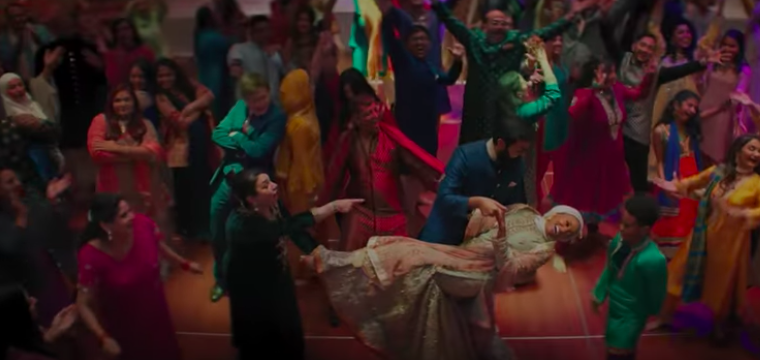 A group of people dance at a wedding