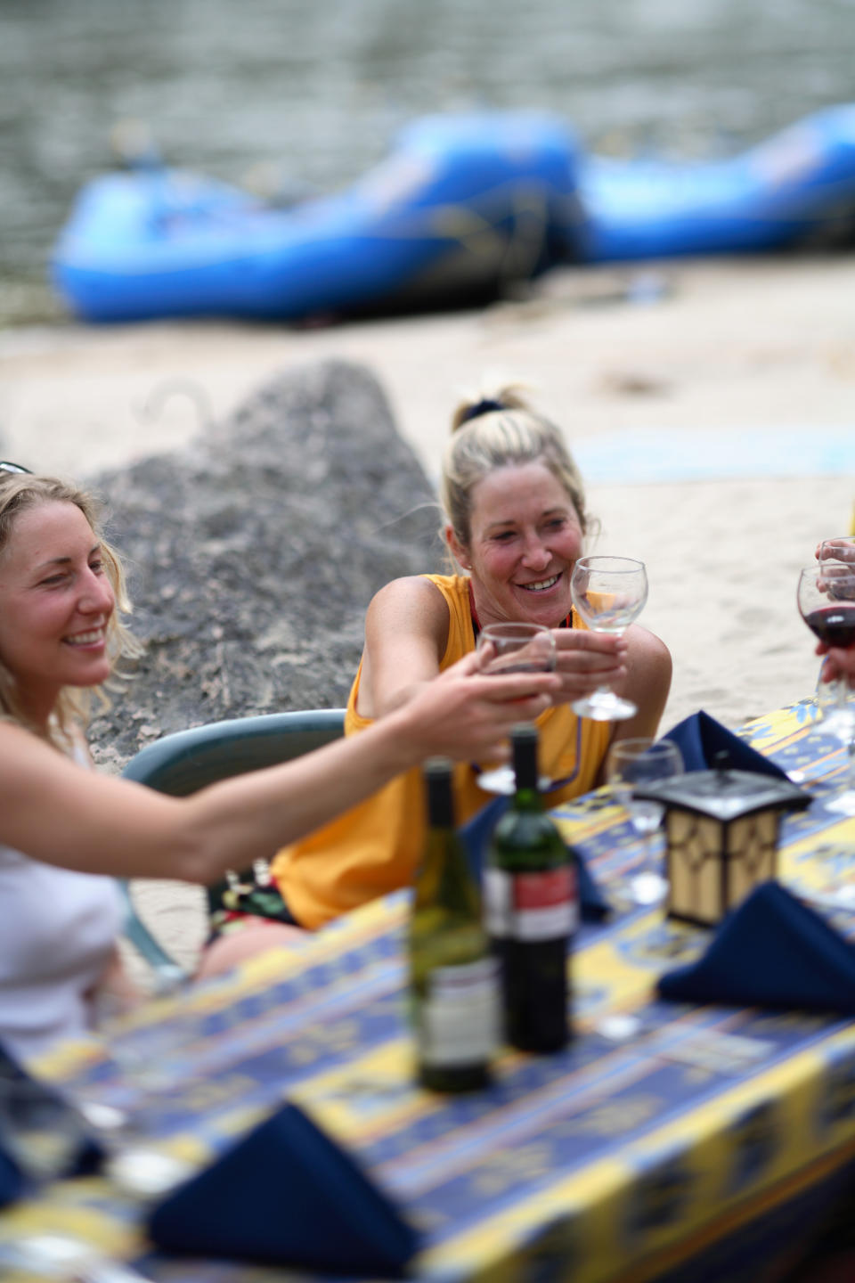 This undated photo released by Far and Away Adventures shows campers drinking wine on a "glamping" _ glamour camping _ expedition on the Middle Fork of Idaho's Salmon River, also known as the River of No Return. Participants go whitewater rafting and sleep in tents, but they also dine on elegant meals served on linen tablecloths with wine, and yoga sessions and massages are provided. (AP Photo/Far and Away Adventures)