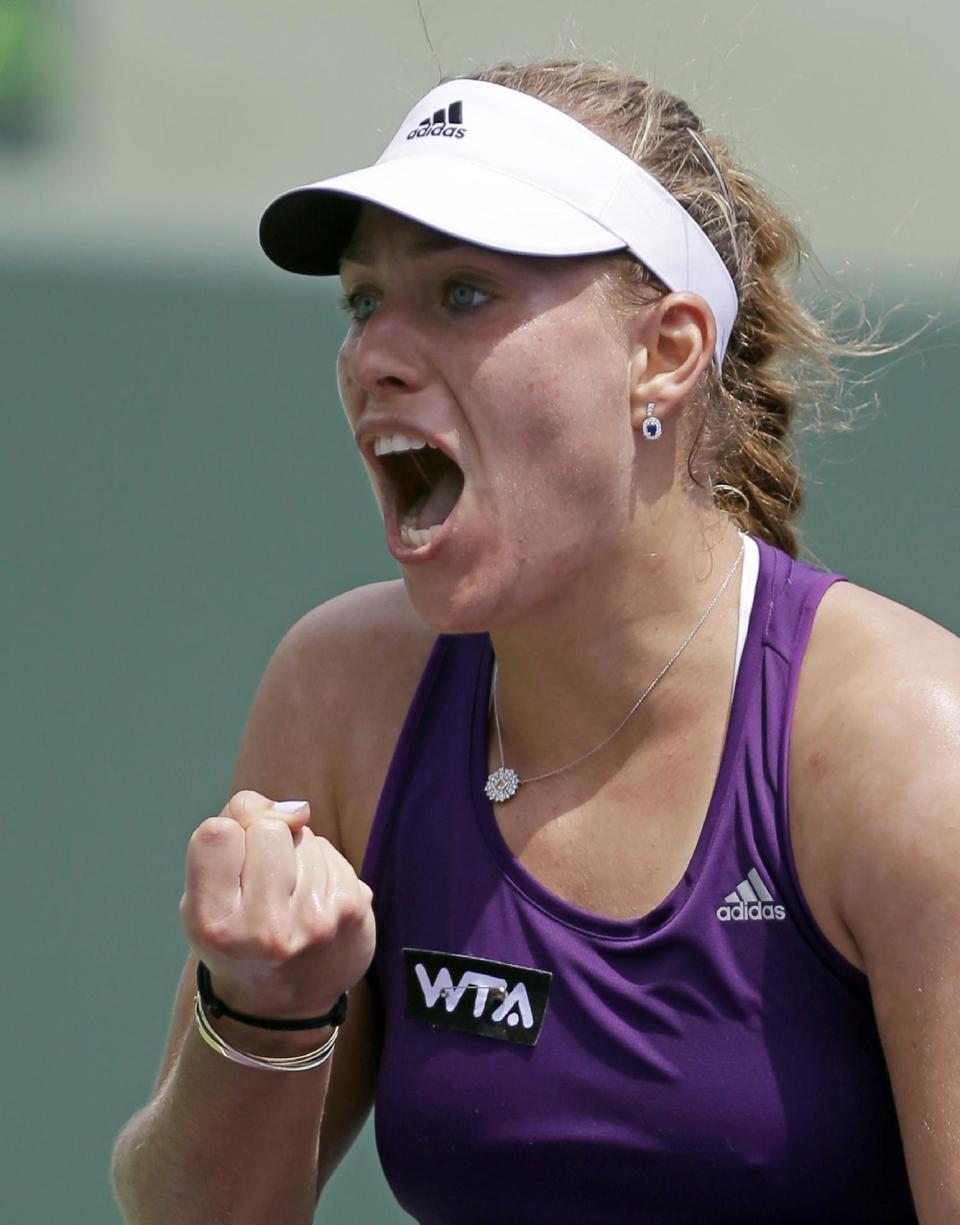 Angelique Kerber, of Germany, celebrates after defeating 6-3, 1-6, 7-6, Peng Shuai, of China, at the Sony Open tennis tournament in Key Biscayne, Fla., Thursday, March 20, 2014. (AP Photo/Alan Diaz)
