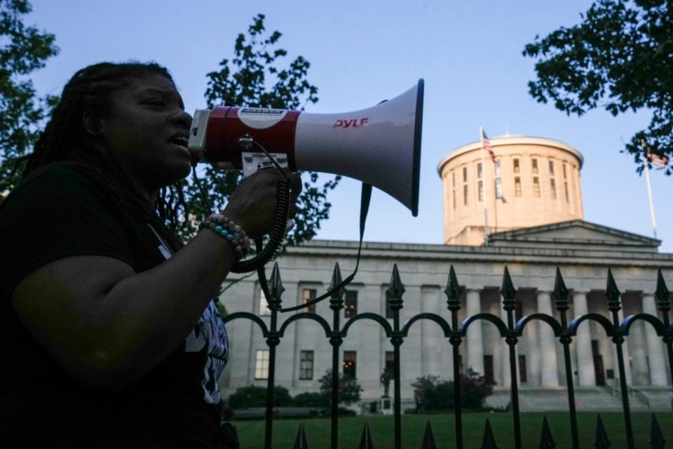 May 20, 2023; Columbus, Ohio, US;  LaQuisa Richardson, CEO of community group Advocate, Connect and Empower, speaks into a megaphone in front of the Ohio Statehouse during a protest for Sinzae Reed, a 13-year-old who was shot and killed in Columbus’ Hilltop neighborhood on Oct. 12, 2022 by Krieg Butler. A Franklin County grand jury recently declined to file murder charges for Butler.