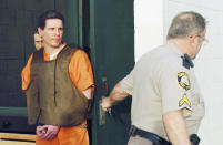 FILE - Scott Eizember, left, is taken out of the Canadian County Jail by members of the Creek County Sheriff's Office after a jury approved the death penalty Eizember, Friday, Feb. 25, 2005, in El Reno, Okla. The Oklahoma Court of Criminal Appeals on Friday, July 1, 2022, set execution dates for six death row inmates, just hours before an attorney for one planned to ask for a rehearing in his case. Execution dates for James Coddington, Richard Glossip, Benjamin Cole, Richard Fairchild, John Hanson and Scott Eizember were scheduled, starting Aug. 25 with Coddington and followed on Sept. 22 with Glossip(AP Photo/The Oklahoman, Michael Downes File)