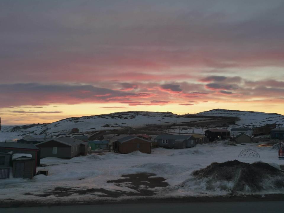 In this May 7, 2020 photo provided by Aaron Watson, the sun sets over Iqaluit, the capital of Nunavut territory in far north Canada. Iqaluit has a population of about 7,000 people, many of whom are Inuit. Watson says, so far, there are no cases of coronavirus in the town. (AP Photo via Aaron Watson)