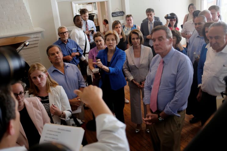 Elizabeth Warren and Nancy Pelosi, center, huddle with other Democratic leaders in a coffee shop before unveiling their “Better Deal” plan. (Photo: James Lawler Duggan/Reuters)