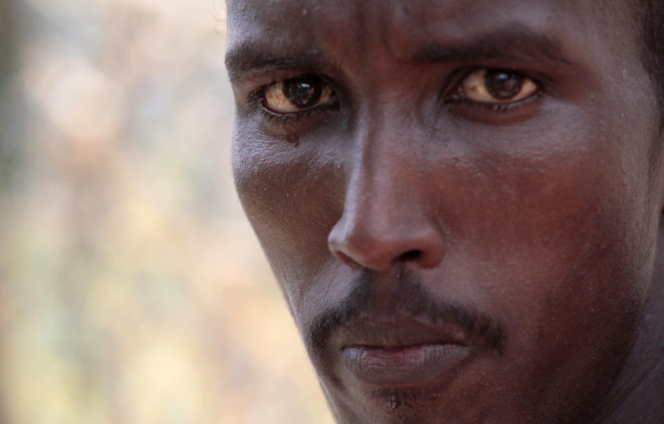 A Somali inmate detained in an anti-piracy operation conducted by Seychelles Coast Guard, pauses as he works at the incarceration block in Montagne Posee near Victoria, Seychelles, Friday, March 2, 2012. (AP Photo/Gregorio Borgia)