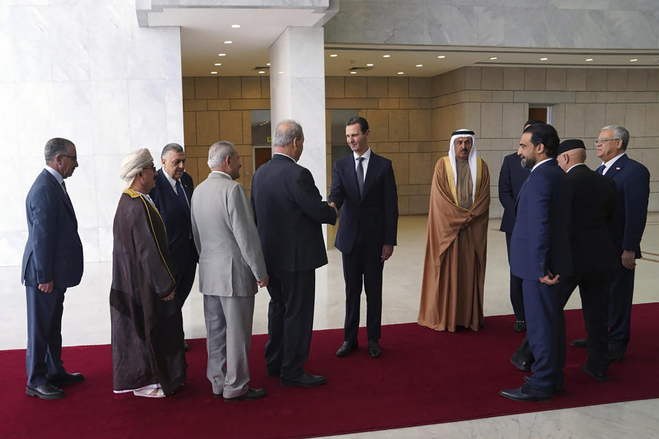 In this photo released by the official Telegram account of the Syrian Presidency, Syrian President Bashar Assad, center, meets a delegation representing various Arab parliaments in Damascus, Sunday, Feb. 26, 2023. (Syrian Presidency via Telegram via AP)