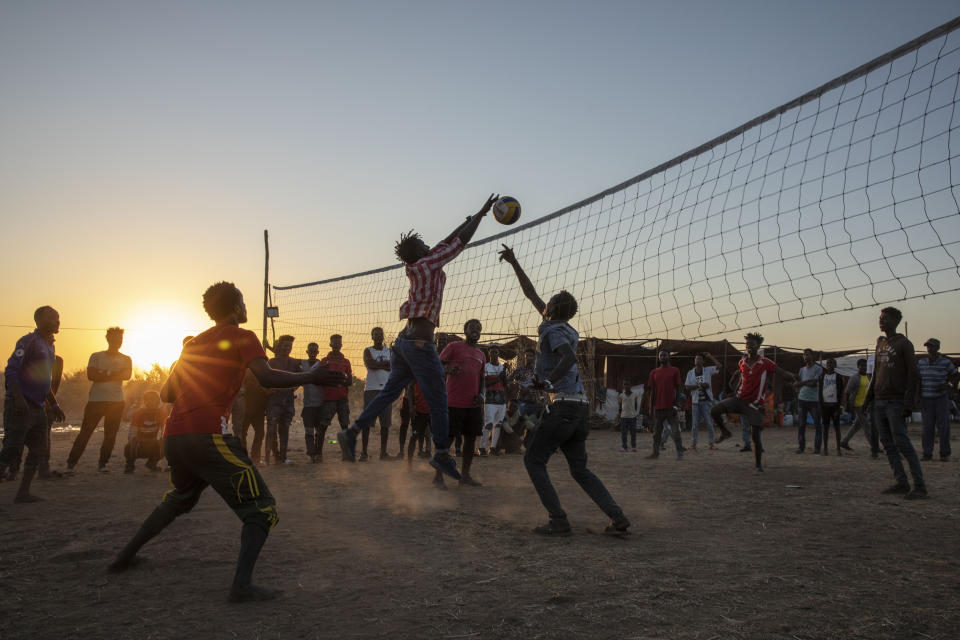 Tigray refugees who fled the conflict in Ethiopia's Tigray region, play volleyball at Um Rakuba refugee camp in Qadarif, eastern Sudan, Monday, Nov. 23, 2020. Tens of thousands of people have fled a conflict in Ethiopia for Sudan, sometimes so quickly they had to leave family behind. There is not enough to feed them in the remote area of southern Sudan that they rushed to. (AP Photo/Nariman El-Mofty)