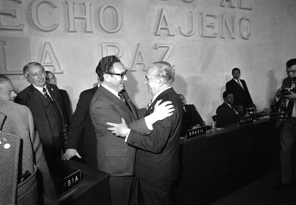 FILE - U.S. Secretary of State Henry Kissinger, left, embraces Argentine foreign minister Alberto J. Vignes as they say goodbye at the end of the Latin foreign ministers conference in Mexico City, Feb. 23, 1974. Leftists in Chile were tortured during the military dictatorship of Gen. Augusto Pinochet and in Argentina, many were "disappeared" by members of the brutal military dictatorship that held detainees in concentration camps. It all happened with the endorsement of Henry Kissinger, the former U.S. secretary of state. Many countries were scarred deeply during the Cold War by human rights abuses inflicted in the name of anti-communism and where many still harbor a deep distrust of their powerful neighbor to the north. (AP Photo, File)